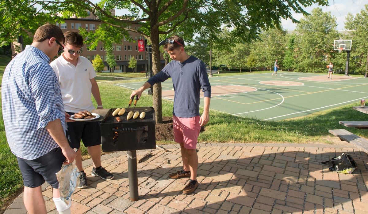 Male students grilling outside