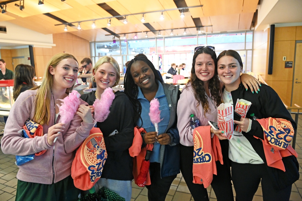 female students with popcorn and cotton candy at Cardianl Palooza