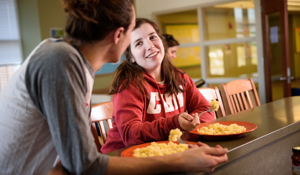 Students eating pasta in residence hall 