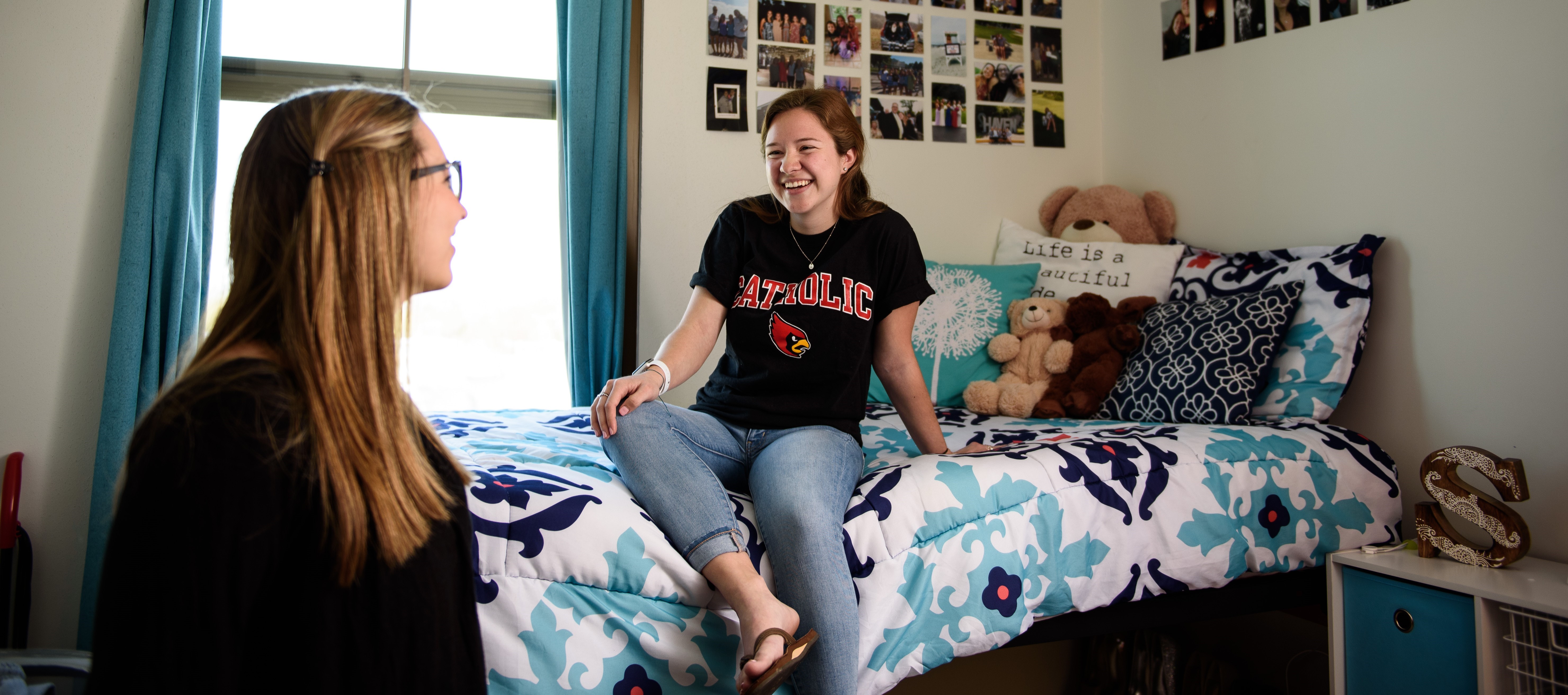 Female students laughing in dorm room